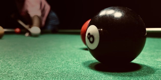 close up of pool balls on table, can see grains in pool felt