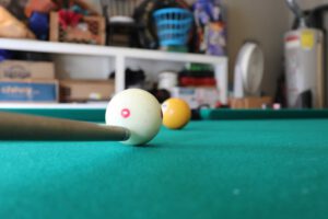 Close up view of the cue tip lined up under the center of the cue ball