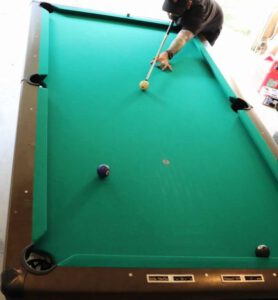 Photo of a long straight shot lined up across the pool table