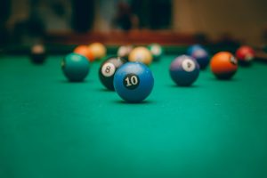 a photo of balls laying on a pool table